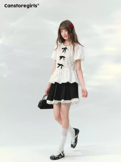 “Polka Soufflé” White Polka Dot Bow Peplum Blouse