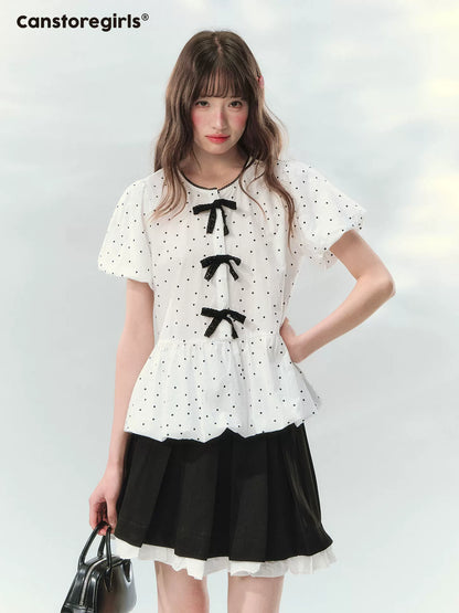 “Polka Soufflé” White Polka Dot Bow Peplum Blouse