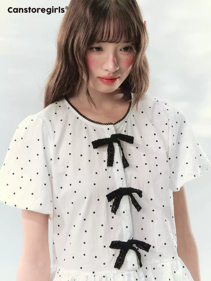 “Polka Soufflé” White Polka Dot Bow Peplum Blouse